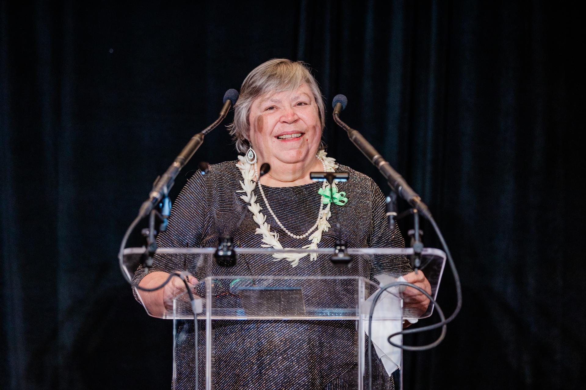 closeup of woman speaking on a podium 