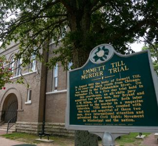 signage of a historical marker that says "emmett till murder trial"