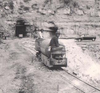 Navajo miners exit a mine in Cove, Arizona, on top of a small train.