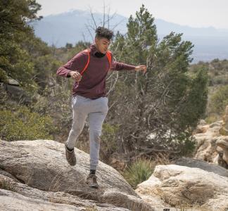 Young hiker on rocks in Saguaro National Park Park, Arizona