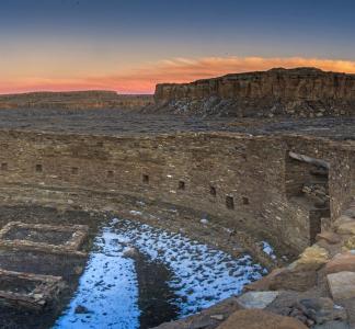 A view of the Chaco Canyon ruins with the sunset on the background.