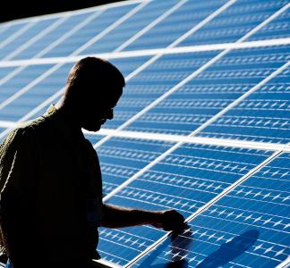 Person touching a solar panel 