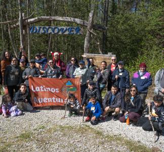 people gathering with a banner that says "latino aventureros"