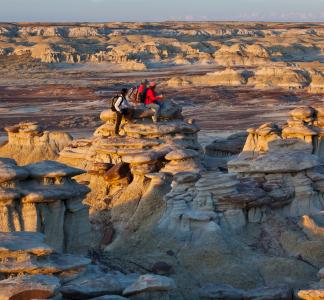 3 People sit atop a rocky landscape at the Ah-shi-sle-pah Wilderness