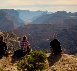 people sitting looking over mountains