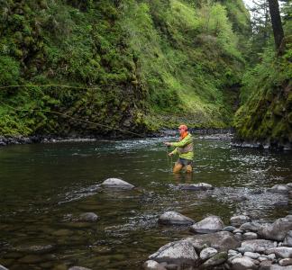 man fishing on river