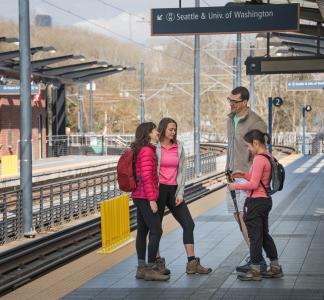 Hikers in Seattle, Washington awaiting public transit to a trailhead.