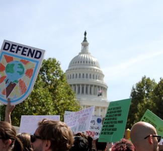 A sign that says "DEFEND" outside of the nation's capital at the 2019 Global Climate Strike