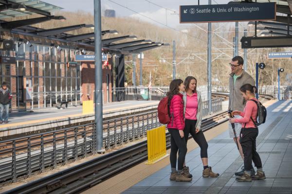 Hikers in Seattle, Washington awaiting public transit to a trailhead.