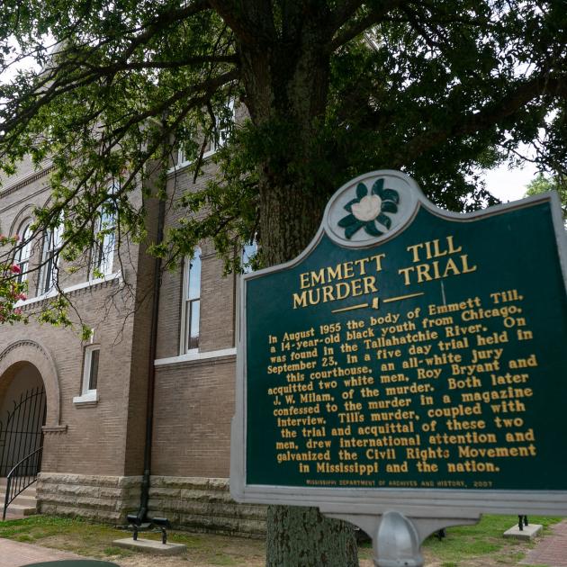 signage of a historical marker that says "emmett till murder trial"