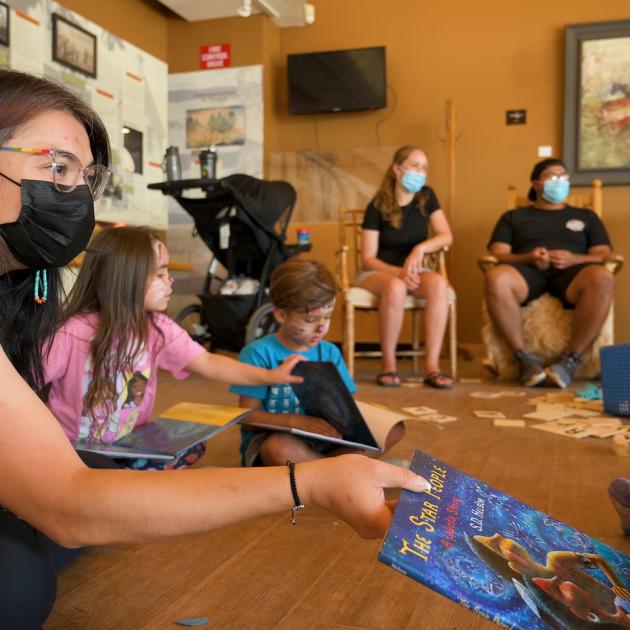 women surrounded by kids 