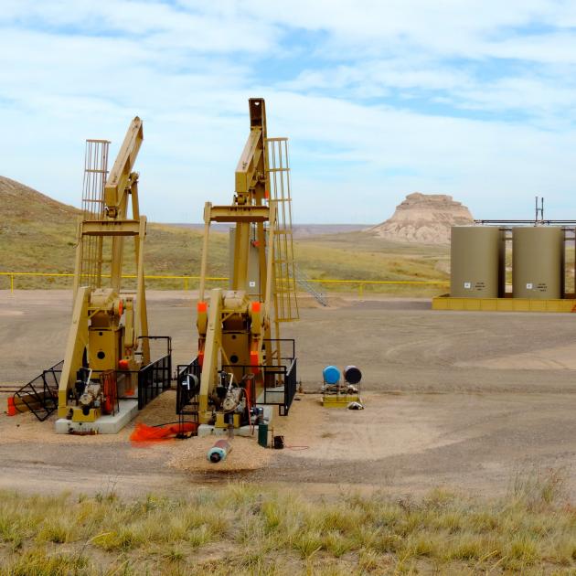 Two oil pumpjacks in rolling, open landscape, Pawnee National Grassland, Colorado