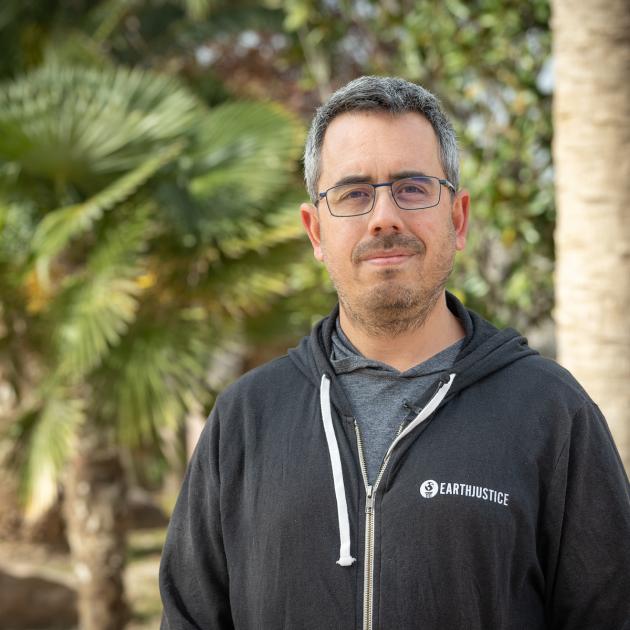 Portrait of man with palm trees in the background