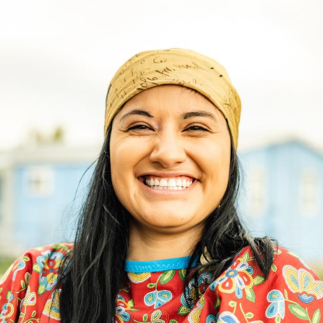 Portrait of a person looking into the camera and wearing traditional dress.