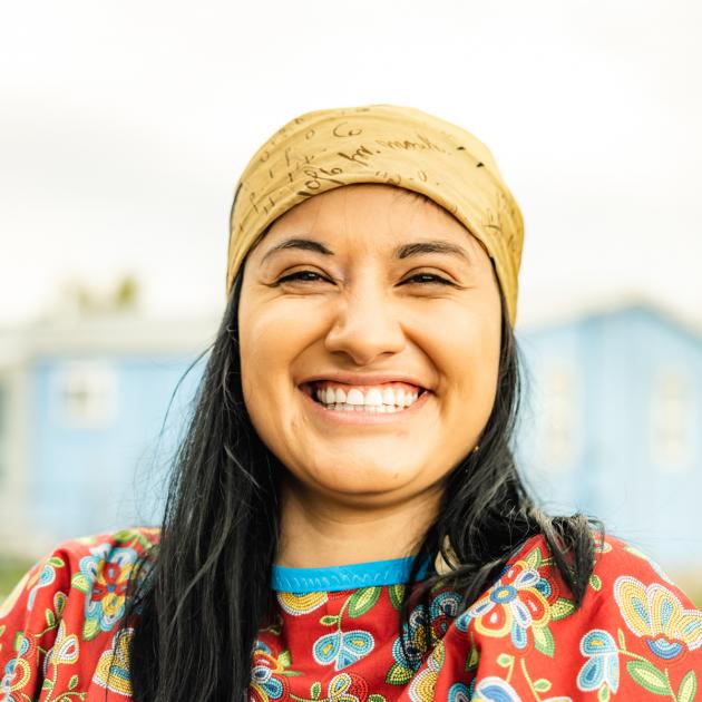 Portrait of a person looking into the camera and wearing traditional dress. 