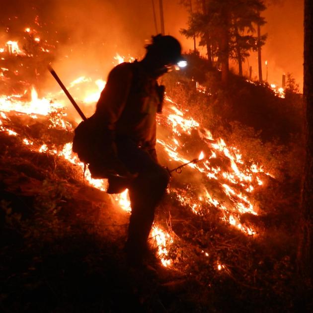 A firefighter in front of a wildfire in Lolo National Forest, Montana