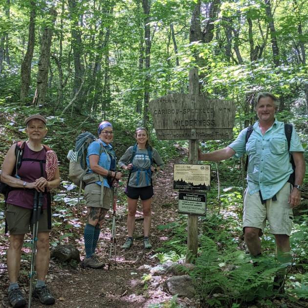 people posing for photo surrounded by forest