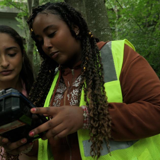 two teenagers checking water quality