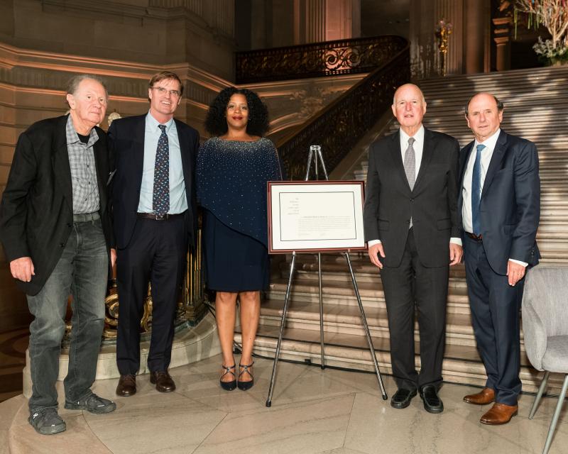 six people stand side by side wearing professional clothing