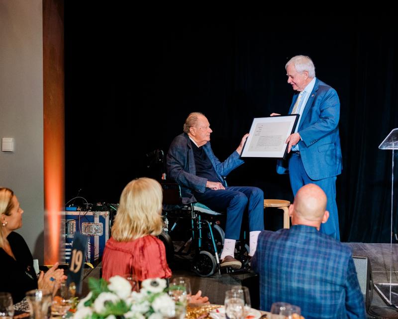 person in wheelchair receiving award