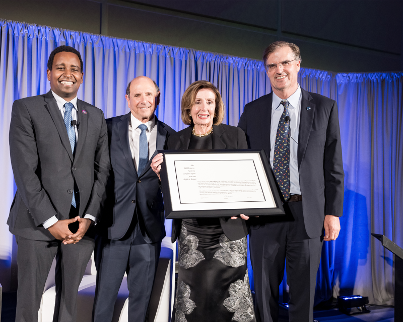 nancy pelosi next to three men including TWS president Jamie williams