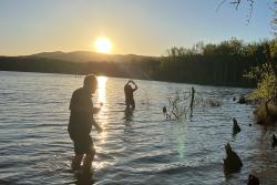 two people on a lake with sunset 